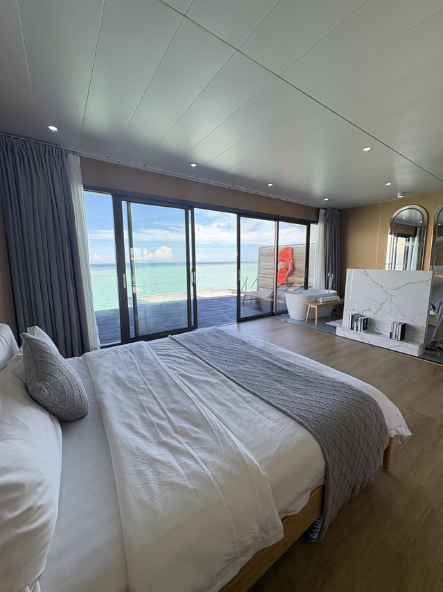 Modern bed inside a sleek bedroom at Sicily Hotel in the Celebes Sea