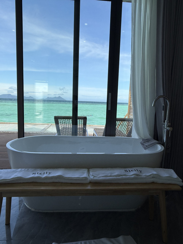 Close-up of white soaking tub at Sicily Hotel with ocean view