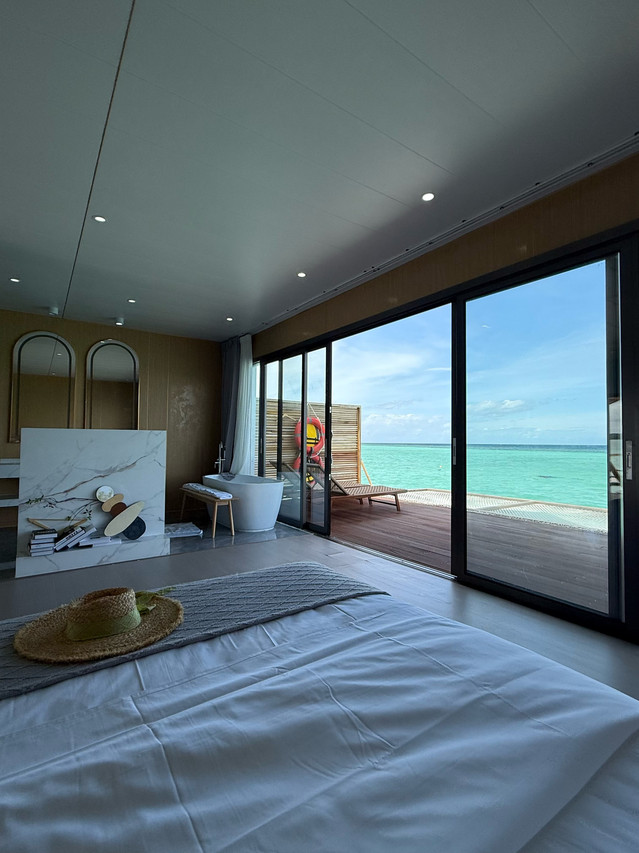 Comfortable bed inside a warm bedroom at Sicily Resort