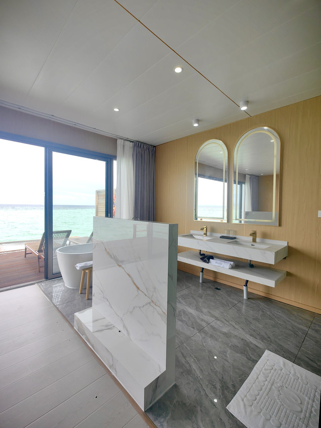 Beautifully designed modern bathroom at Sicily Hotel with arched mirrors