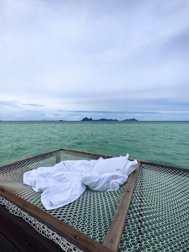 Private ocean-facing sun balcony with hanging egg chair at Sicily Resort