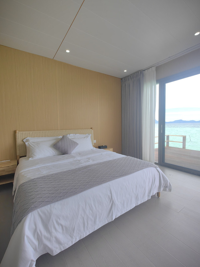 Luxurious king bed inside a spacious bedroom at Sicily Hotel