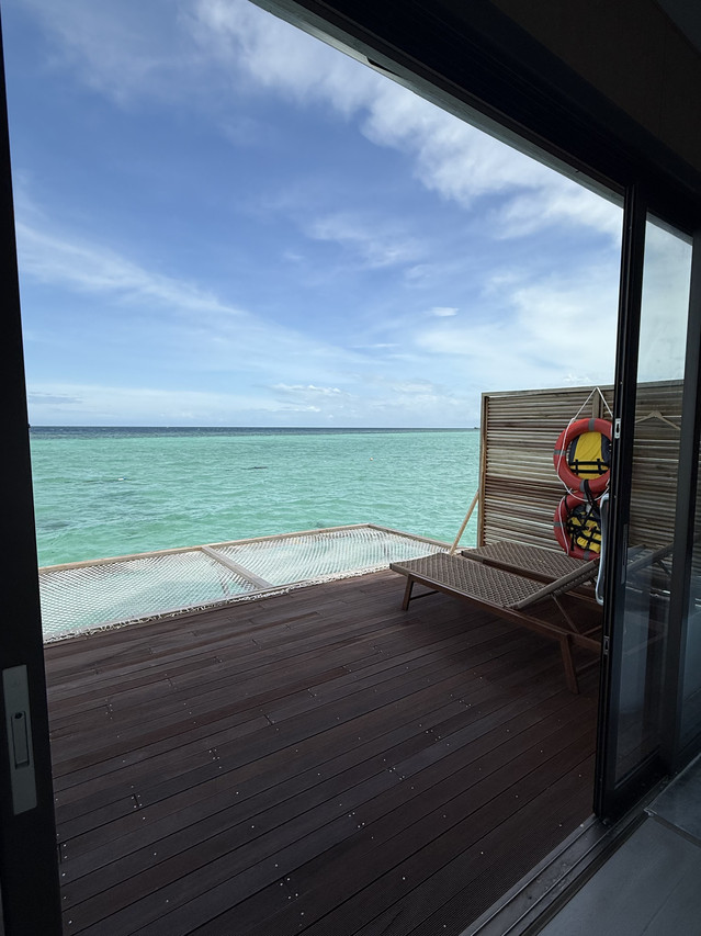 Private sun-soaked balcony with wooden loungers at Sicily Resort