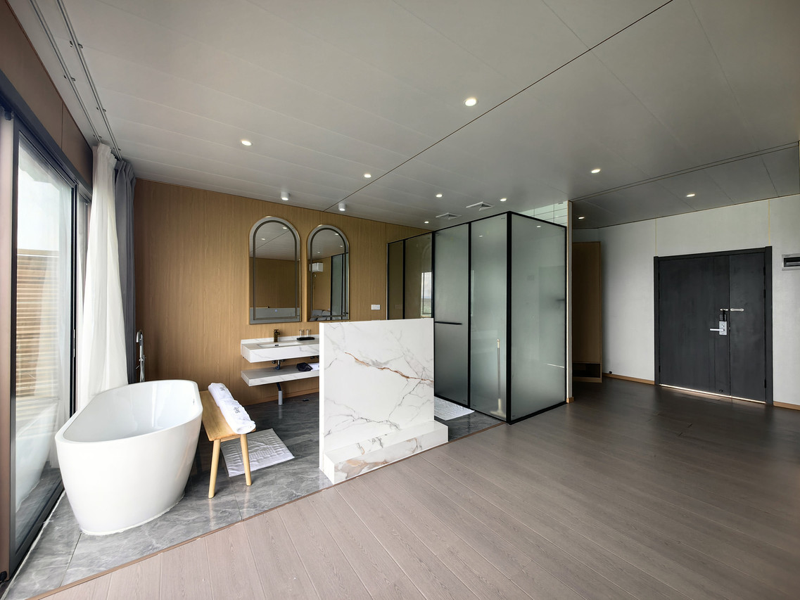 Spacious open-concept bathroom featuring white soaking tub at Sicily Hotel