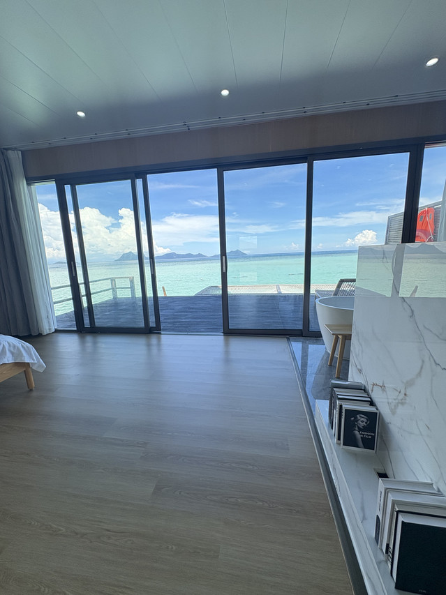 Luxurious bedroom at Sicily Hotel featuring panoramic ocean views
