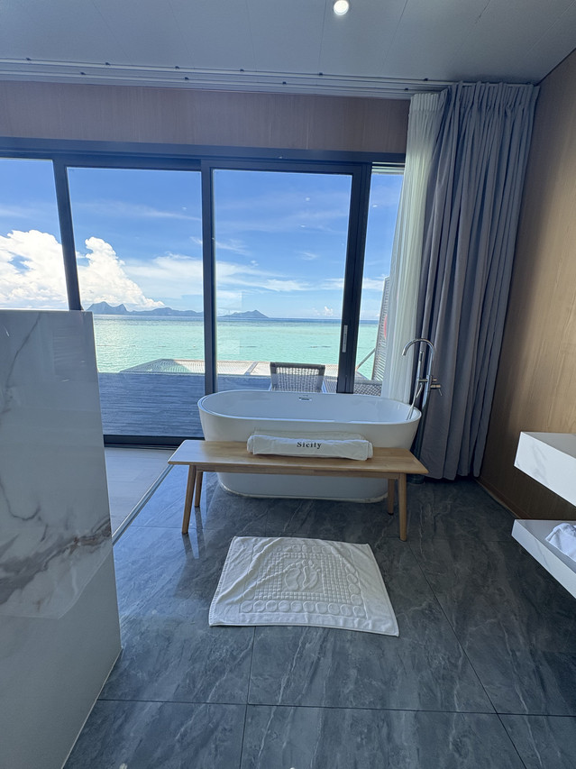 Sophisticated bathroom at Sicily Hotel featuring freestanding tub and deck view