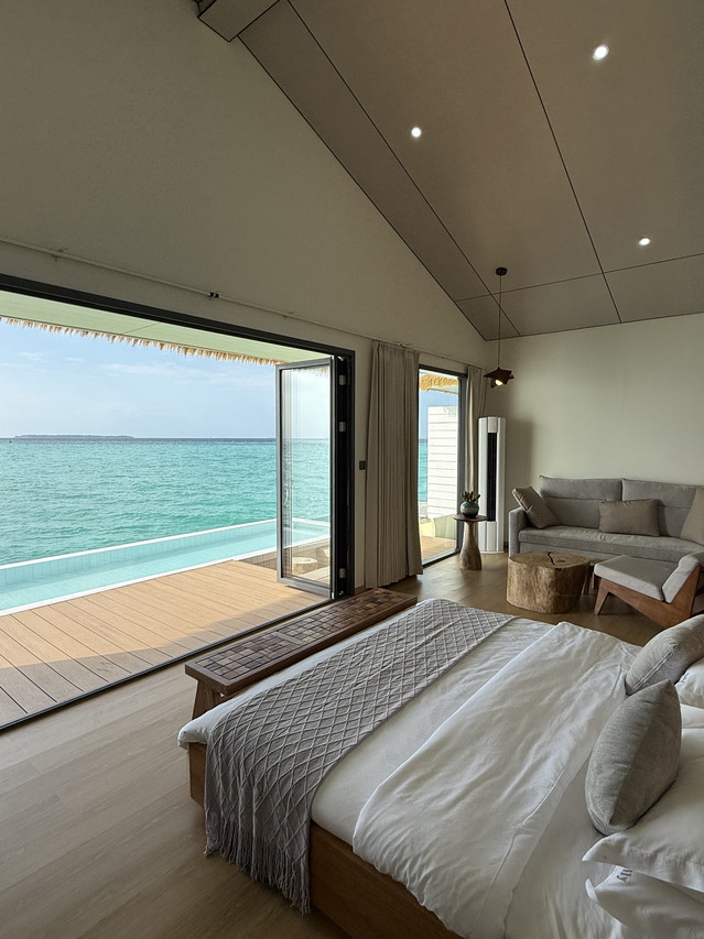Stunning master bedroom at Sicily Hotel near Semporna showing large bed facing ocean balcony