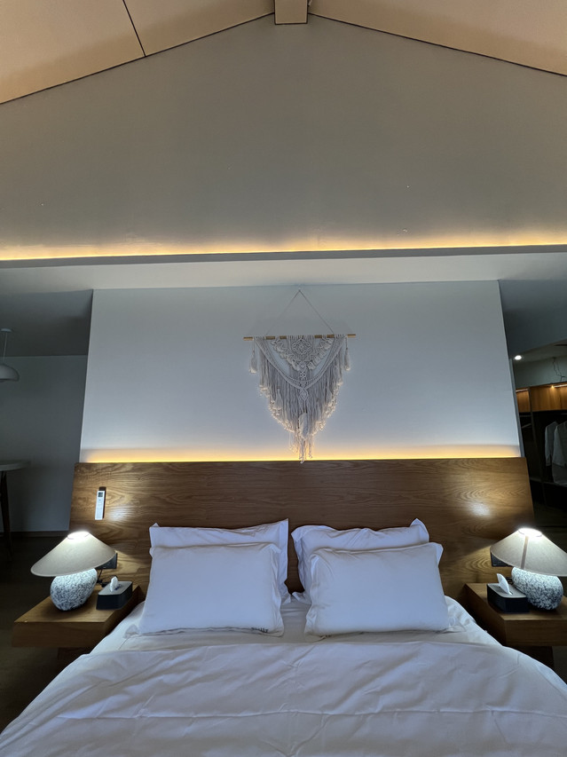 Comfortable bed inside stylish boho-chic bedroom at Sicily Hotel