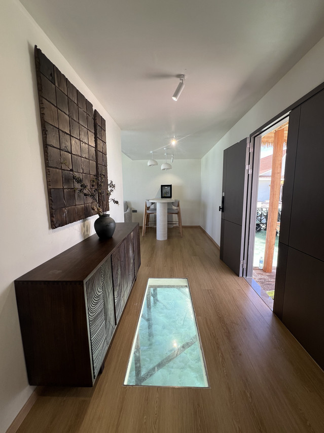 Spacious room at Sicily Hotel near Semporna featuring glass floor hallway